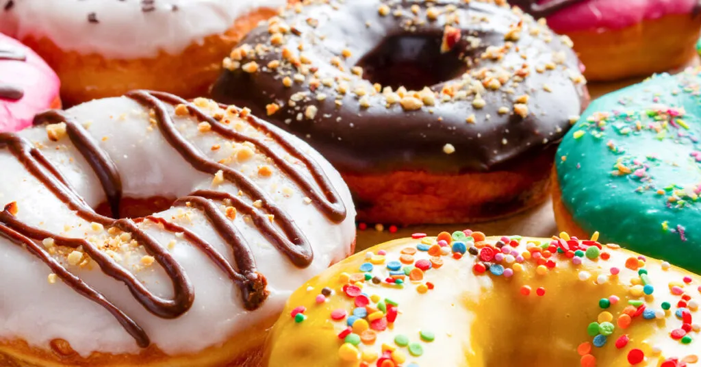 Brightly colored donuts in a bakery.